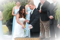 Wedding image of married couple pouring drink together in a glass